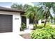 This home boasts a two-car garage, a secure front door, and meticulously manicured landscaping with palm trees at 2614 67Th W St, Bradenton, FL 34209