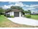 Charming single-story home with a well-manicured lawn, a long driveway, and a two-car garage at 2614 67Th W St, Bradenton, FL 34209