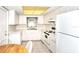 A cozy kitchen with all-white cabinets, tile floors, and essential appliances for easy meal prep at 2614 67Th W St, Bradenton, FL 34209