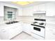 Bright kitchen featuring white cabinetry, tile floors, and modern appliances at 2614 67Th W St, Bradenton, FL 34209