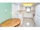 Bright kitchen with white cabinets, appliances, and tile floor with an adjacent breakfast nook at 2614 67Th W St, Bradenton, FL 34209