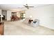 Spacious living room featuring carpet floors and comfortable seating area next to dining room at 2614 67Th W St, Bradenton, FL 34209