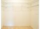 Empty walk-in closet with metal shelves and tile floor at 2614 67Th W St, Bradenton, FL 34209
