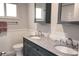Bathroom featuring double vanity with granite countertop, toilet, and dark blue cabinets at 2722 Nancy St, Sarasota, FL 34237
