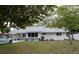 Charming single-story home with well-maintained lawn and mature trees, freshly painted in neutral tones at 2722 Nancy St, Sarasota, FL 34237