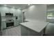 Updated kitchen featuring stainless steel appliances, light blue cabinetry and a spacious kitchen island at 2722 Nancy St, Sarasota, FL 34237