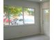 Bright living room featuring a large window and a white front door at 2722 Nancy St, Sarasota, FL 34237