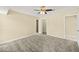 Spacious bedroom with plush gray carpeting, ceiling fan, and ample closet space at 27255 Deep Creek Blvd, Punta Gorda, FL 33983