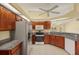 This kitchen features granite countertops, stainless appliances, and wood cabinetry with tile floors at 27255 Deep Creek Blvd, Punta Gorda, FL 33983