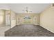 Bright living room featuring a bay window, neutral walls, plush carpet and a ceiling fan at 27255 Deep Creek Blvd, Punta Gorda, FL 33983