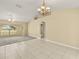 Bright living room featuring neutral tones, tile flooring, chandelier, and large windows at 27255 Deep Creek Blvd, Punta Gorda, FL 33983