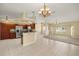 Open concept kitchen/living room featuring modern stainless appliances, tile floors and chandelier at 27255 Deep Creek Blvd, Punta Gorda, FL 33983