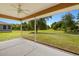 Inviting screened-in porch with ceiling fan overlooking the expansive, green backyard at 27255 Deep Creek Blvd, Punta Gorda, FL 33983