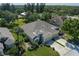 Aerial view of home shows landscaping, mature trees and three-car garage at 3312 92Nd E Ave, Parrish, FL 34219