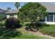 This backyard features lush plants, mature trees and a screened patio at 3312 92Nd E Ave, Parrish, FL 34219