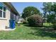 Beautiful backyard with flowering bushes, mature trees, and well-maintained lawn, perfect for relaxation at 3312 92Nd E Ave, Parrish, FL 34219