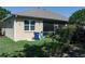 Exterior view of the backyard with greenery, a screened lanai and a trash bin at 3312 92Nd E Ave, Parrish, FL 34219