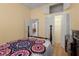 Bright bedroom features a decorative quilt, wood floors and a closet at 3312 92Nd E Ave, Parrish, FL 34219