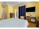 Bedroom with light walls, hardwood floors, and window with curtains and access to the pool at 3312 92Nd E Ave, Parrish, FL 34219