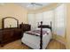 Bedroom with wood floors, four-post bed, bay window and dresser at 3312 92Nd E Ave, Parrish, FL 34219