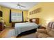 Bedroom with yellow walls, ceiling fan, and neutral-toned furnishings creating a cozy atmosphere at 3312 92Nd E Ave, Parrish, FL 34219