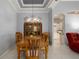 Elegant dining room featuring tray ceiling, chandelier, and an open view to the kitchen at 3312 92Nd E Ave, Parrish, FL 34219