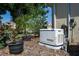 Exterior shot featuring a home generator surrounded by landscaping and potted plants at 3312 92Nd E Ave, Parrish, FL 34219