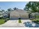 Beautiful home with a three-car garage, manicured lawn and lush landscaping at 3312 92Nd E Ave, Parrish, FL 34219