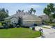 Well-manicured home featuring a spacious three-car garage and lush landscaping at 3312 92Nd E Ave, Parrish, FL 34219