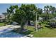 Home with a mature tree in the front yard, lush landscaping, and a well-maintained lawn for curb appeal at 3312 92Nd E Ave, Parrish, FL 34219