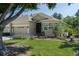 Inviting single-story home with attached two-car garage, well-manicured lawn, and lush landscaping at 3312 92Nd E Ave, Parrish, FL 34219