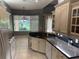 A modern kitchen with granite countertops, stainless steel appliances, and ample natural light at 3312 92Nd E Ave, Parrish, FL 34219