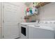 Functional laundry room with a washing machine, dryer, and shelving for storage at 3312 92Nd E Ave, Parrish, FL 34219