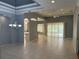 Open-concept living room with high ceilings, tile flooring, and sliding glass doors leading to the outdoors at 3312 92Nd E Ave, Parrish, FL 34219