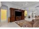Bright living room showcasing tile floors, modern furniture, and a large entertainment center at 3312 92Nd E Ave, Parrish, FL 34219