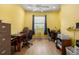 Office space with laminate wood flooring, a ceiling fan, and furniture at 3312 92Nd E Ave, Parrish, FL 34219