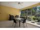 Screened lanai has a ceiling fan and table with chairs for relaxing at 3312 92Nd E Ave, Parrish, FL 34219