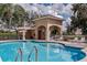 Inviting community pool featuring clear blue water, lounge chairs, and covered patio area at 3312 92Nd E Ave, Parrish, FL 34219