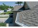 Close-up of a home's new roof with seamless gutters, in a tranquil neighborhood setting at 3312 92Nd E Ave, Parrish, FL 34219