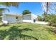 Lush backyard featuring manicured lawn and well-maintained landscaping with outdoor grill at 3417 50Th W St, Bradenton, FL 34209