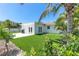 Beautiful backyard with artificial turf, modern patio, and vibrant greenery at 3417 50Th W St, Bradenton, FL 34209