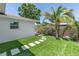 Artificial grass with stepping stones, surrounded by greenery in the backyard at 3417 50Th W St, Bradenton, FL 34209