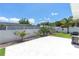 Backyard patio with ample space and grill, bordered by lush greenery and white fencing at 3417 50Th W St, Bradenton, FL 34209