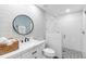 Contemporary bathroom features decorative tile, a circular mirror, and a glass enclosed shower at 3417 50Th W St, Bradenton, FL 34209