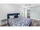 Sunlit bedroom features light blue accents, plank flooring, and an open walk-in closet at 3417 50Th W St, Bradenton, FL 34209