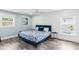 Sunlit bedroom features light blue accents, plank flooring, and bright windows at 3417 50Th W St, Bradenton, FL 34209