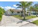Exterior side view with ample parking and lush landscaping around the home at 3417 50Th W St, Bradenton, FL 34209