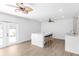 Bright, contemporary kitchen with an island, pendant lights, and double doors to backyard at 3417 50Th W St, Bradenton, FL 34209