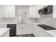 Updated kitchen features white cabinets, stainless steel appliances, and modern backsplash at 3417 50Th W St, Bradenton, FL 34209