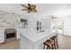 Contemporary kitchen with an island, breakfast bar, stainless steel range, and decorative ceiling fans at 3417 50Th W St, Bradenton, FL 34209